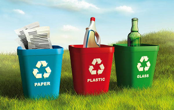 Three bins for representing recycling paper plastic and glass